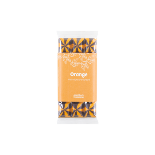Aeschbach Chocolatier Milchschokolade mit Orangenfüllung, zartes Schokoladenstück mit sichtbarer Orangenfüllung innen
