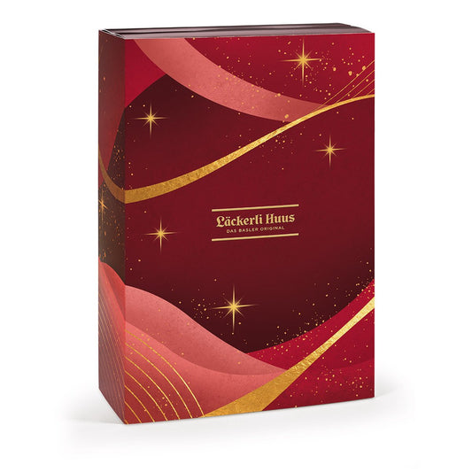 Läckerli Huus Adventskalender Pralinés und Truffes im roten Buchdesign mit goldenen Sternen