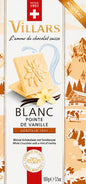 Weiße Schokolade von Chocolat Villars, pur und cremig, in einer offenen Packung auf einem weißen Hintergrund sichtbar.